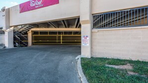 A Red Roof Inn & Suites with a covered parking garage entrance.