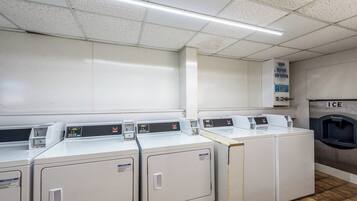 A laundry facility with multiple washing machines, a water softener dispenser, and an ice dispenser.