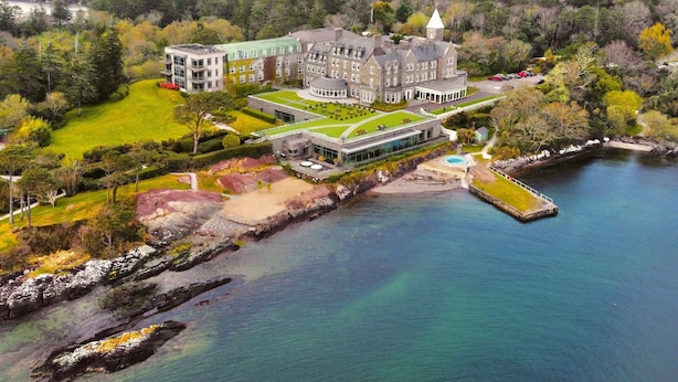 A large, historic building with a central courtyard, surrounded by water and mountains. - Parknasilla Resort and Spa (Sneem)