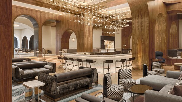 A spacious lobby with a central bar area, multiple seating arrangements, and a modern chandelier. - Signia by Hilton San Jose (San Jose)