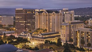 A hotel complex with multiple high-rise buildings, a central building with a dome, and surrounding palm trees. - Signia by Hilton San Jose (San Jose)
