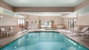 A swimming pool with lounge chairs and a sun terrace.