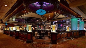 A bar area with a circular ceiling design, a 'Breeze Bar' sign, and a bar counter with stools. - Treasure Island TI Las Vegas - Handwritten Collection (Las Vegas)