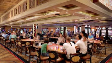 Experience the excitement of gaming at our casino, where tables and slot machines await your next bet.