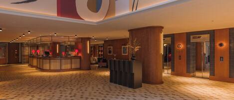 A spacious lobby with a reception desk, a large decorative ceiling, and a patterned floor.