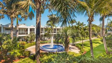 Surrounded by lush greenery and palm trees, this resort offers a serene atmosphere.