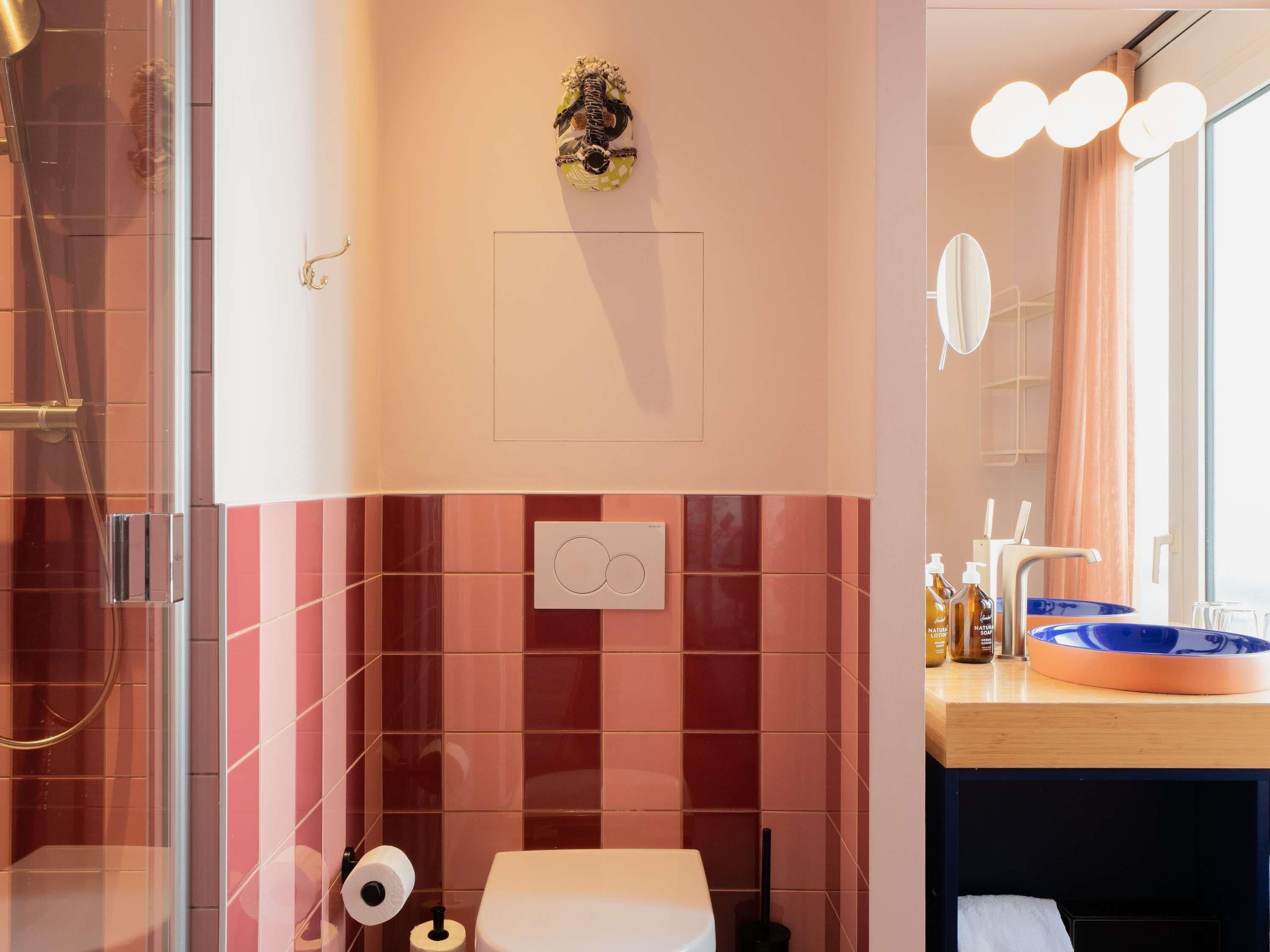 A bathroom with a shower, toilet, and sink.