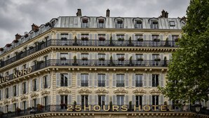 Ein mehrstöckiges Hotel mit Balkonen, einem gut sichtbaren Schild mit der Aufschrift "25 Hours Hotel" und klassischer europäischer Architektur.