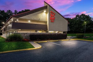 A Red Roof Inn building with a stone facade, a flat roof, and a parking lot. - Red Roof Inn Atlanta South - Morrow (Morrow)