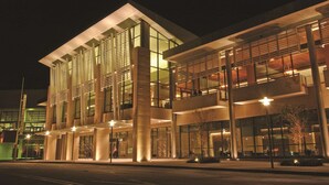 A modern building with large glass windows and a flat roof. - Embassy Suites Hotel Baton Rouge (Baton Rouge)
