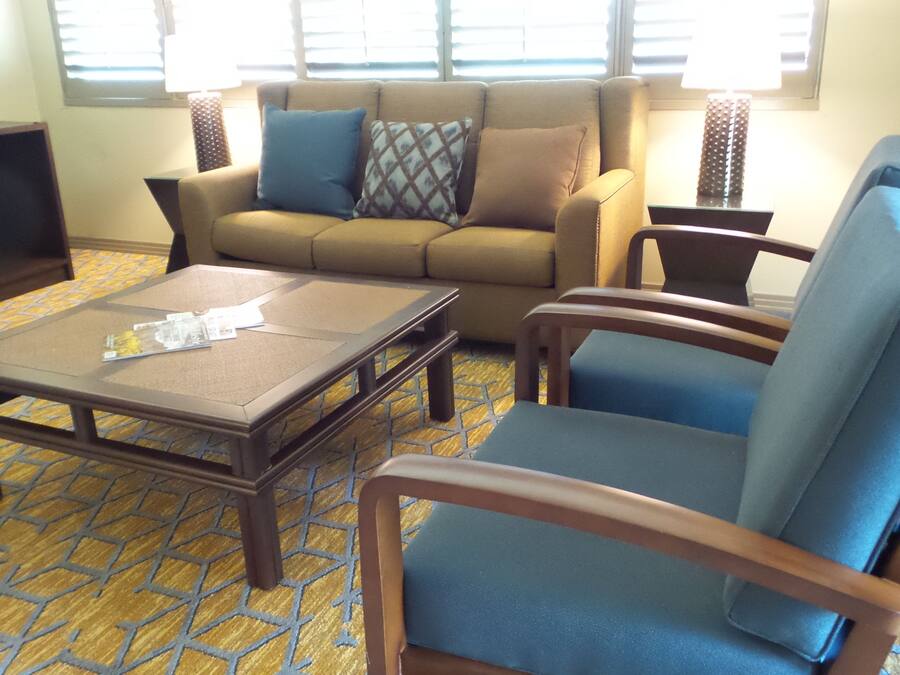 A living room with a sofa, armchair, and coffee table.