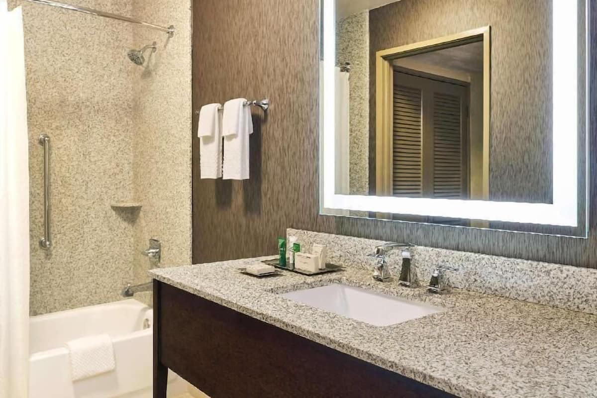 Combined shower/bathtub, designer toiletries, hair dryer, bathrobes