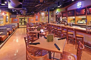 A restaurant with booths, tables, and a bar area.