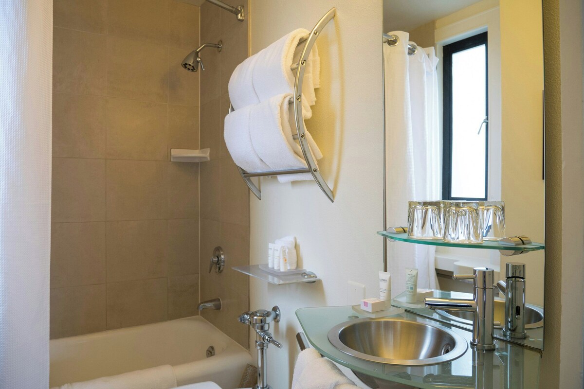 Combined shower/bathtub, designer toiletries, hair dryer, bathrobes