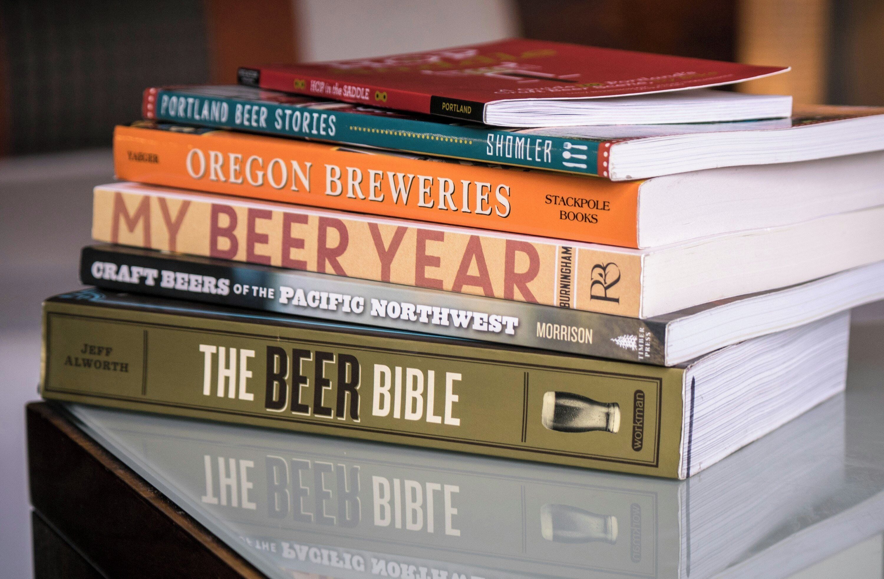 A stack of books with titles related to beer.