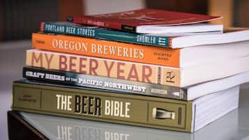 A stack of books with titles related to beer.