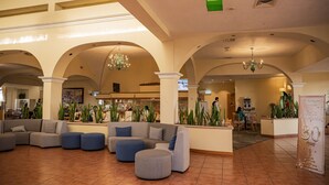 A spacious lobby with a large sectional sofa, a reception desk, and a chandelier. - Holiday Inn La Piedad by IHG (La Piedad)