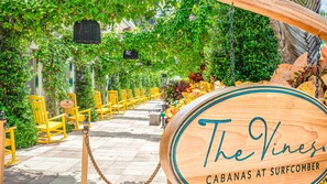 A wooden sign with "The Vine" and "Cabanas at Surfcomber" written on it.