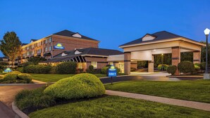 A Days Inn with a brick facade, a covered entrance, and well-maintained landscaping. - Days Inn by Wyndham Hershey (Hershey)