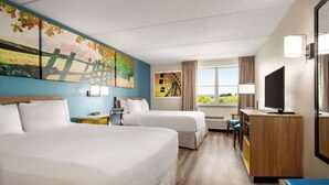 A hotel room with two beds, a desk, a TV, and a large window with a view. - Days Inn by Wyndham Hershey (Hershey)