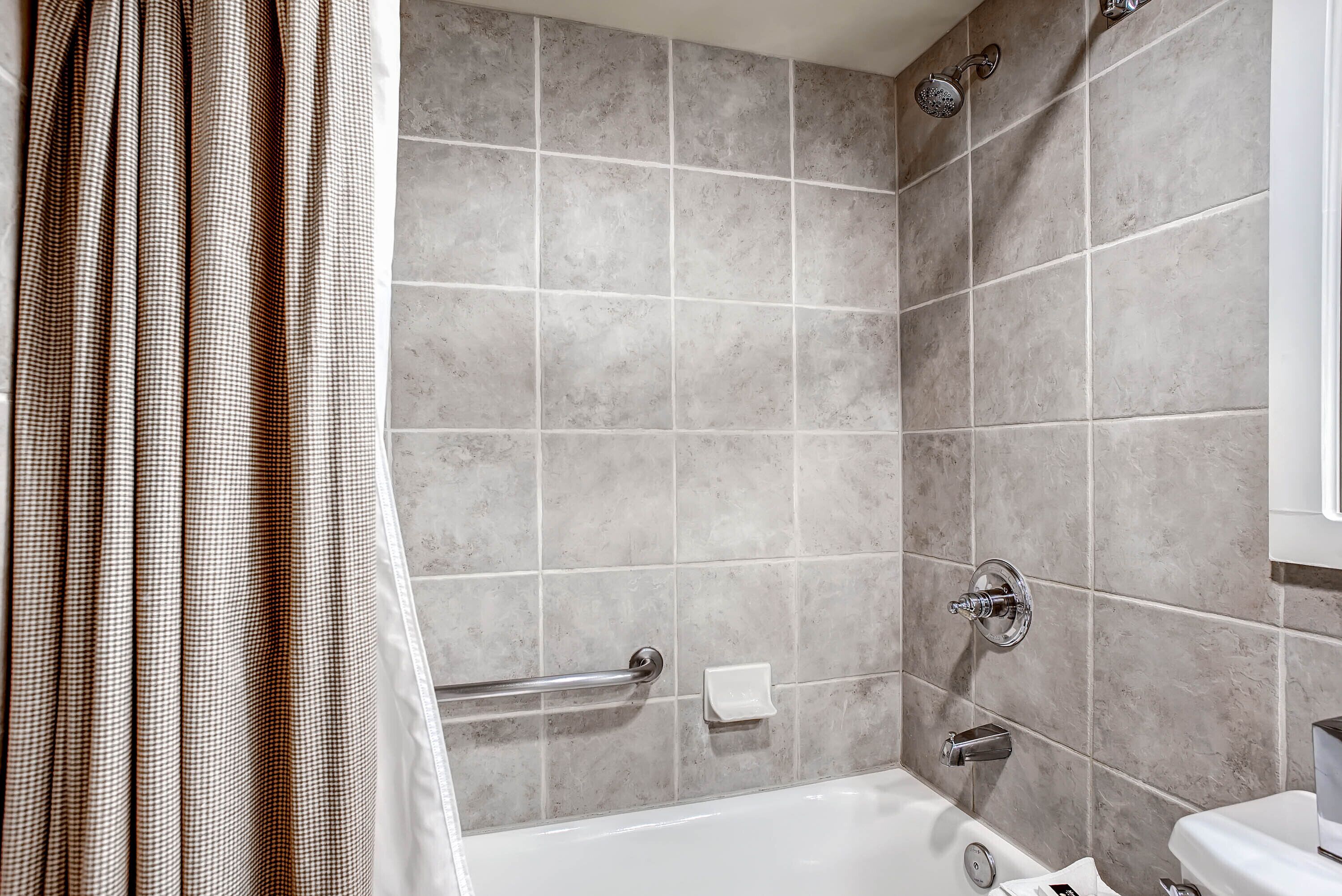 A bathroom with a bathtub, a shower, and a toilet.