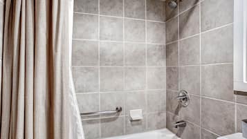 A bathroom with a bathtub, a shower, and a toilet.