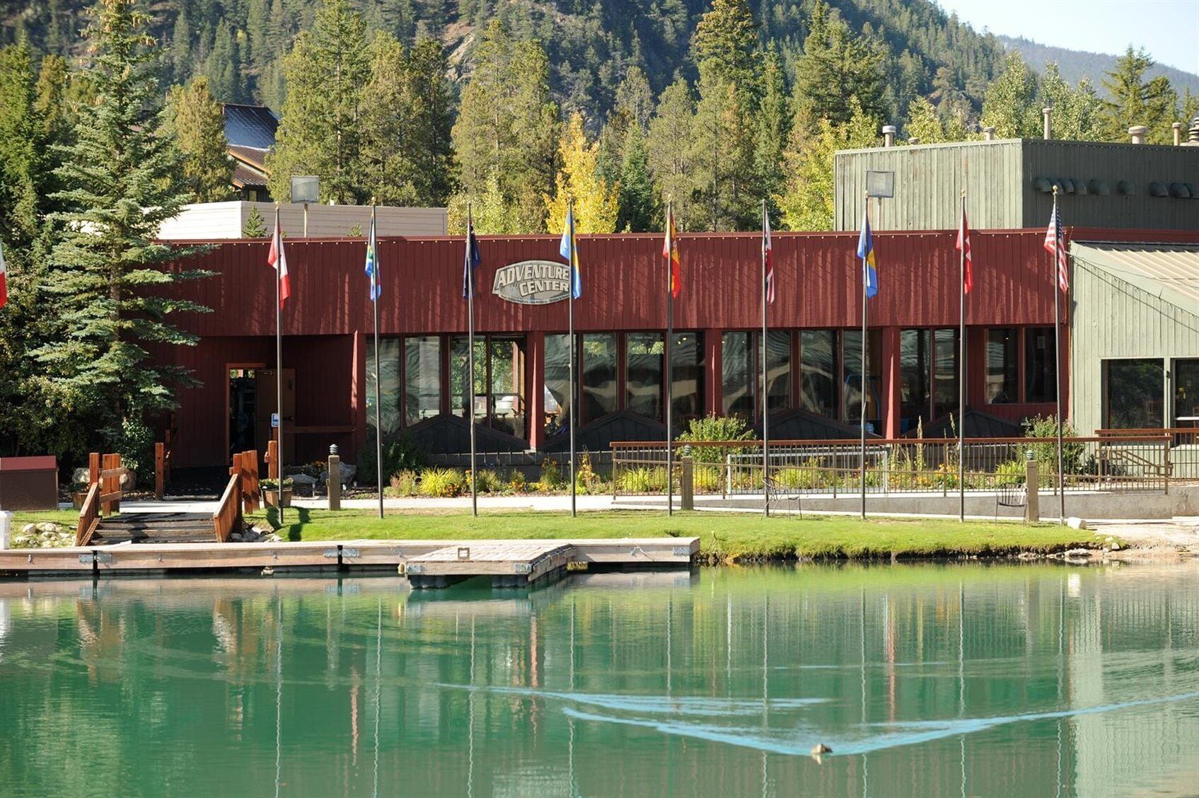 Un edificio con la señalización "Adventure Center" y una piscina frente a él.