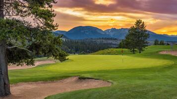 Experience golf amidst majestic mountains and lush surroundings.