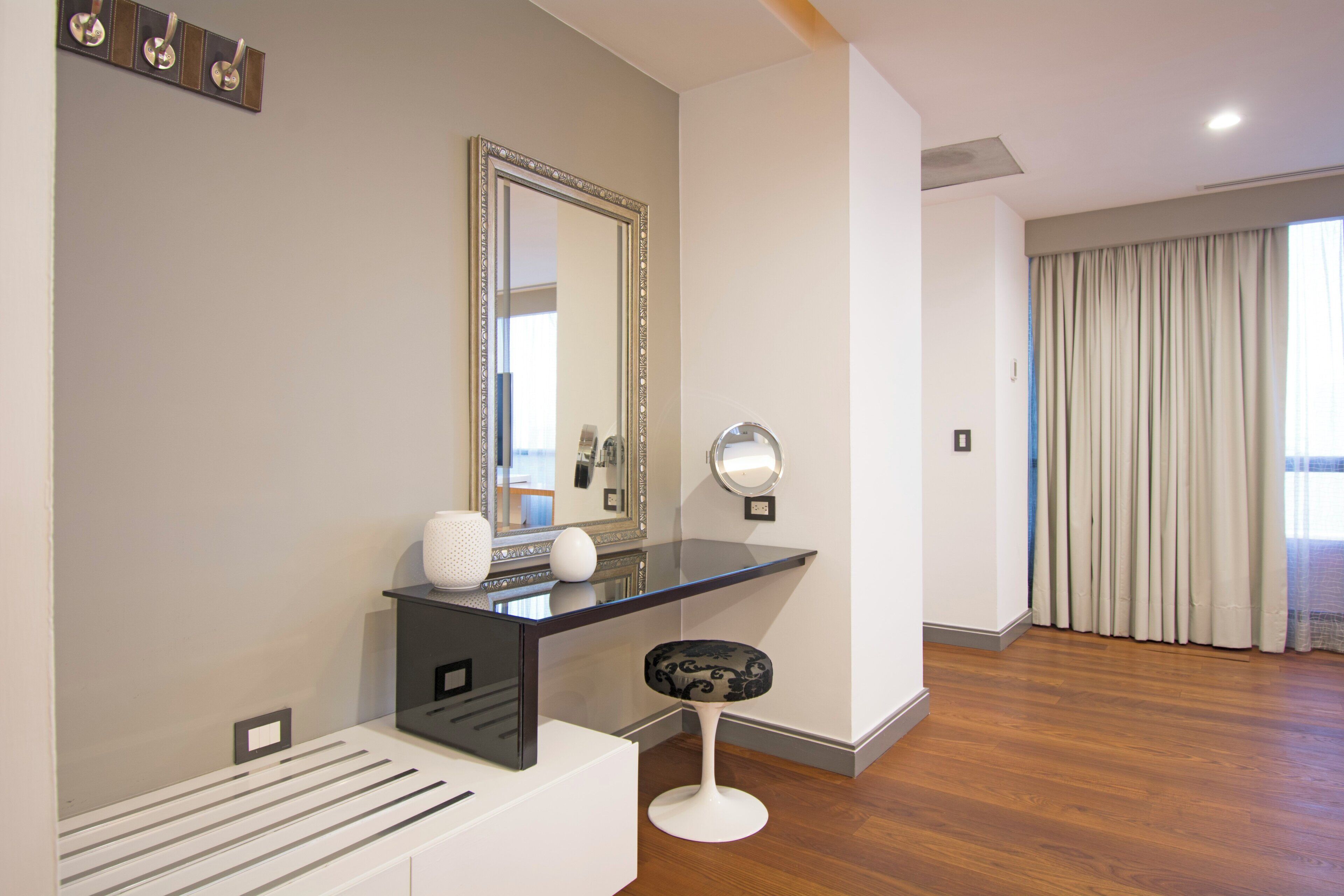 Un baño moderno con tocador, espejo e inodoro.