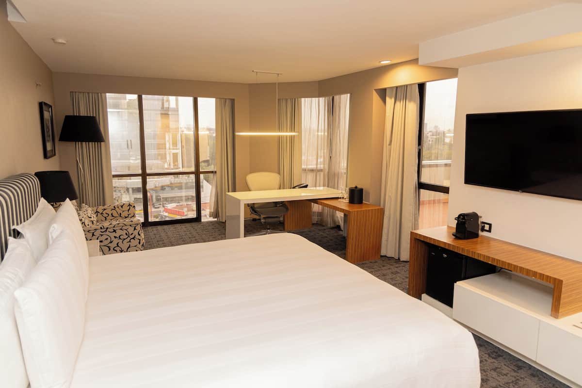 Suite, 1 King Bed, City View (Garden) | 1 bedroom, in-room safe, desk, iron/ironing board