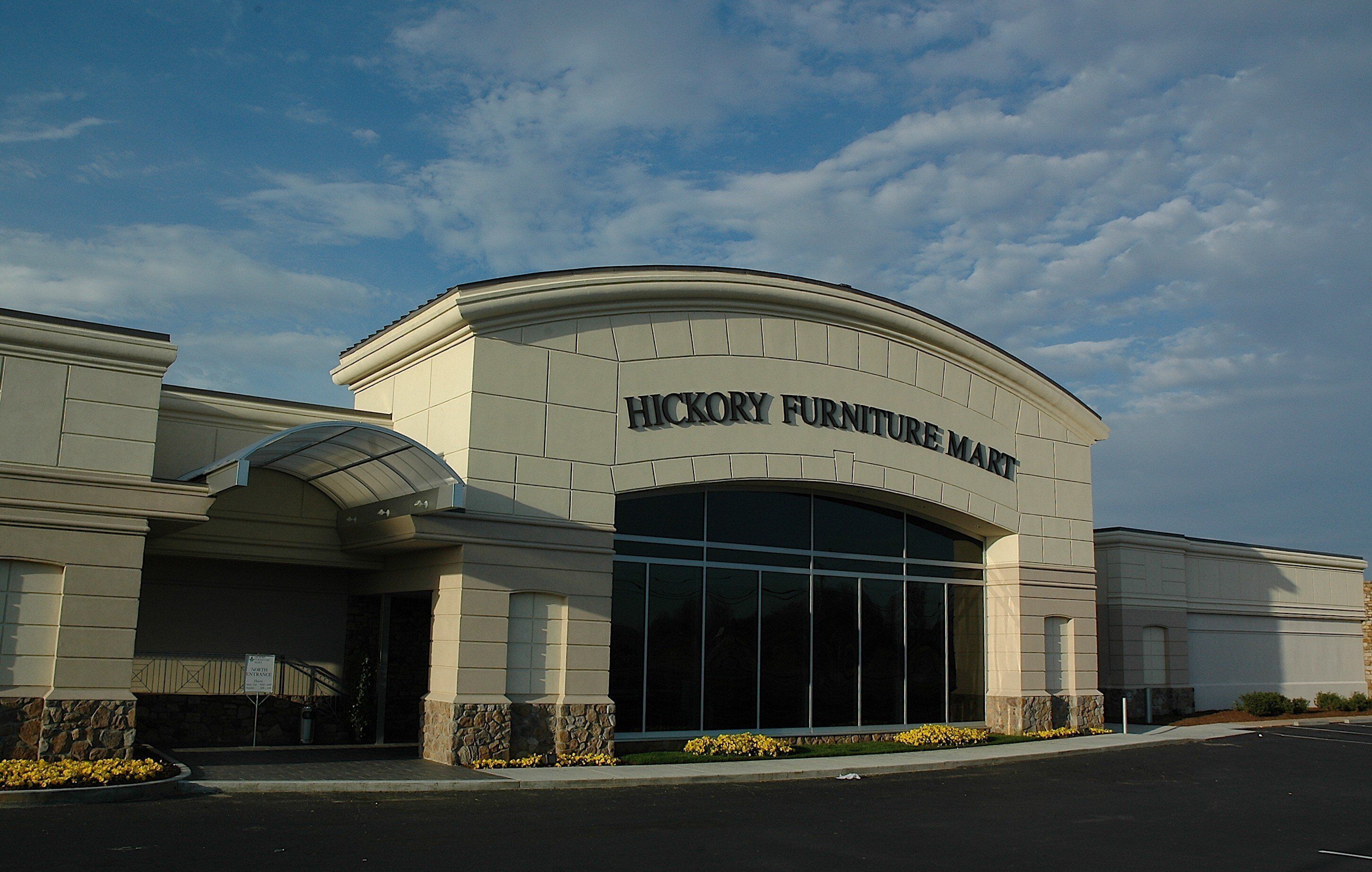 A building with a large arched entrance and the sign 'HICKORY FURNITURE MART' above it.