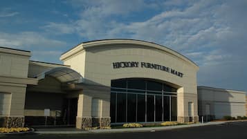 A building with a large arched entrance and the sign 'HICKORY FURNITURE MART' above it.