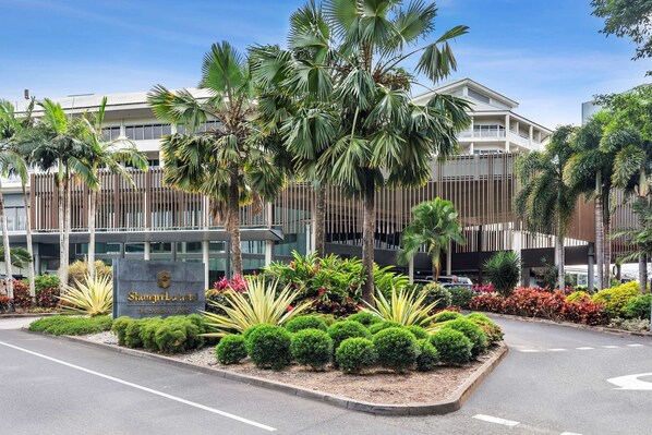 A hotel entrance with a sign reading "Shantala Hotel," surrounded by lush greenery and palm trees. - Shangri-La The Marina, Cairns (Cairns)