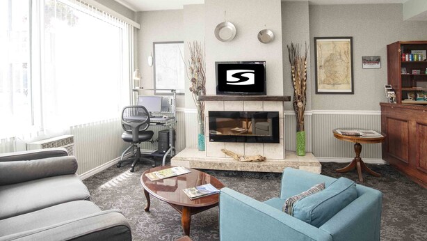 A living room with a fireplace, a television, and seating.