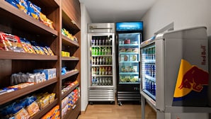A snack and beverage area with shelves stocked with snacks and a refrigerator with beverages. - Fairfield Inn and Suites By Marriott Chesapeake (Chesapeake)