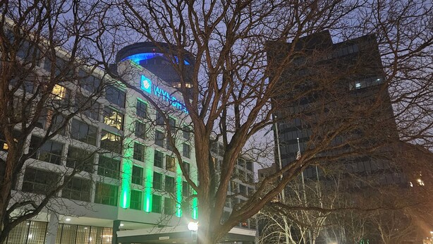 A hotel with a modern design, featuring a prominent 'WYNDHAM' sign on the building. - Wyndham Rochester Downtown (Rochester)