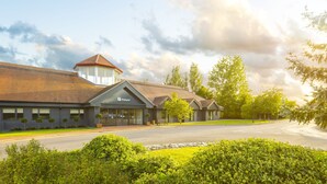 A Holiday Inn Express with a brick facade, a central entrance, and a small tower-like structure. - Holiday Inn Aylesbury by IHG (Aylesbury)