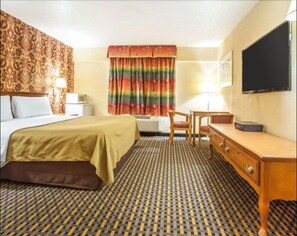 Relax in comfort with a large bed, desk, and flat-screen TV in this inviting space.