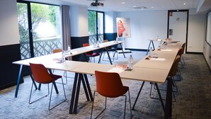 A conference room with a long table, multiple chairs, and a projector screen. - ibis Paris Tour Eiffel Cambronne 15ème (Paris)
