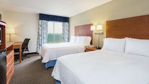 A hotel room with two beds, a desk, a chair, a dresser, and a window with curtains. - Hampton Inn Morehead City (Morehead City)