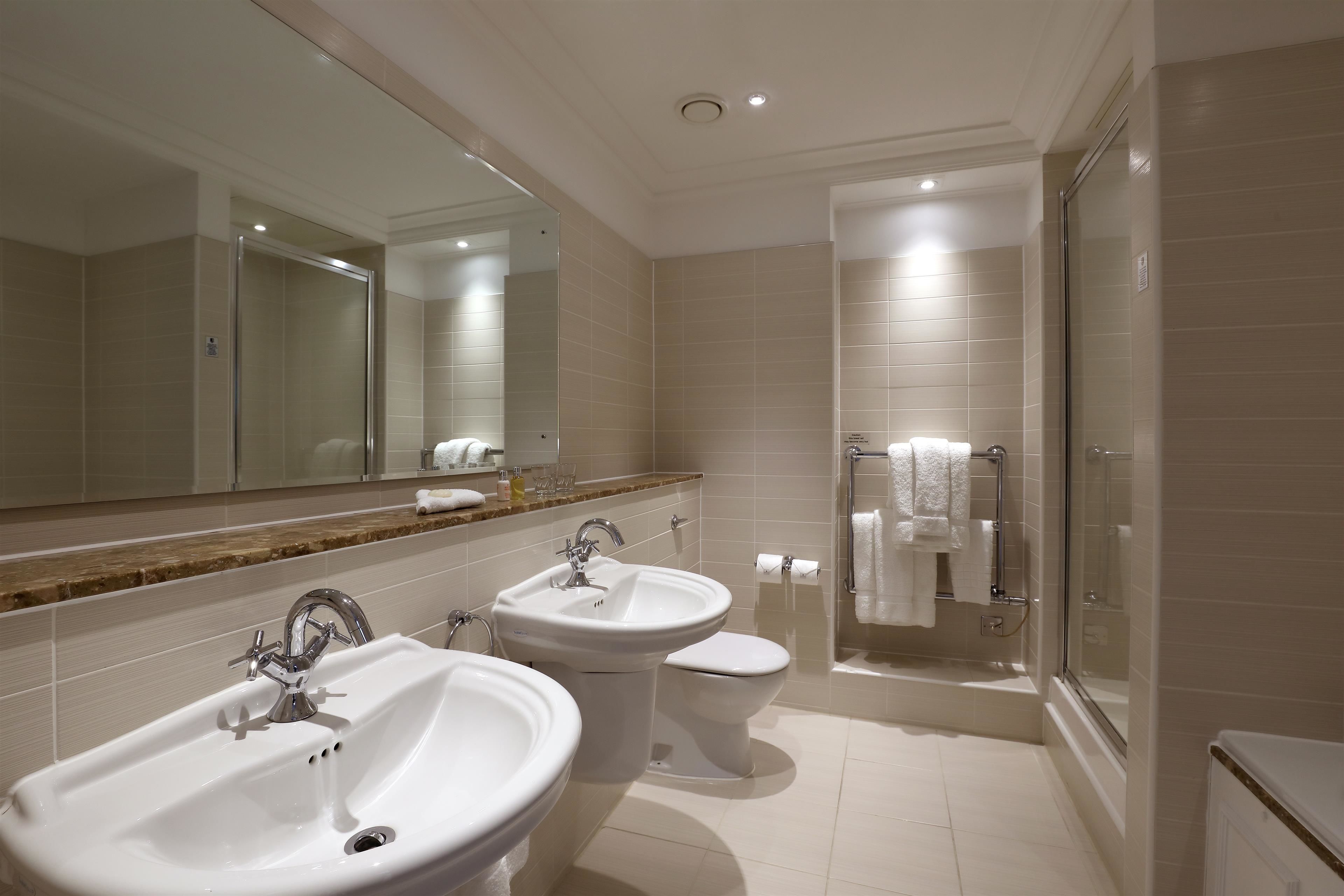 combined shower/bathtub, designer toiletries, hair dryer, bathrobes