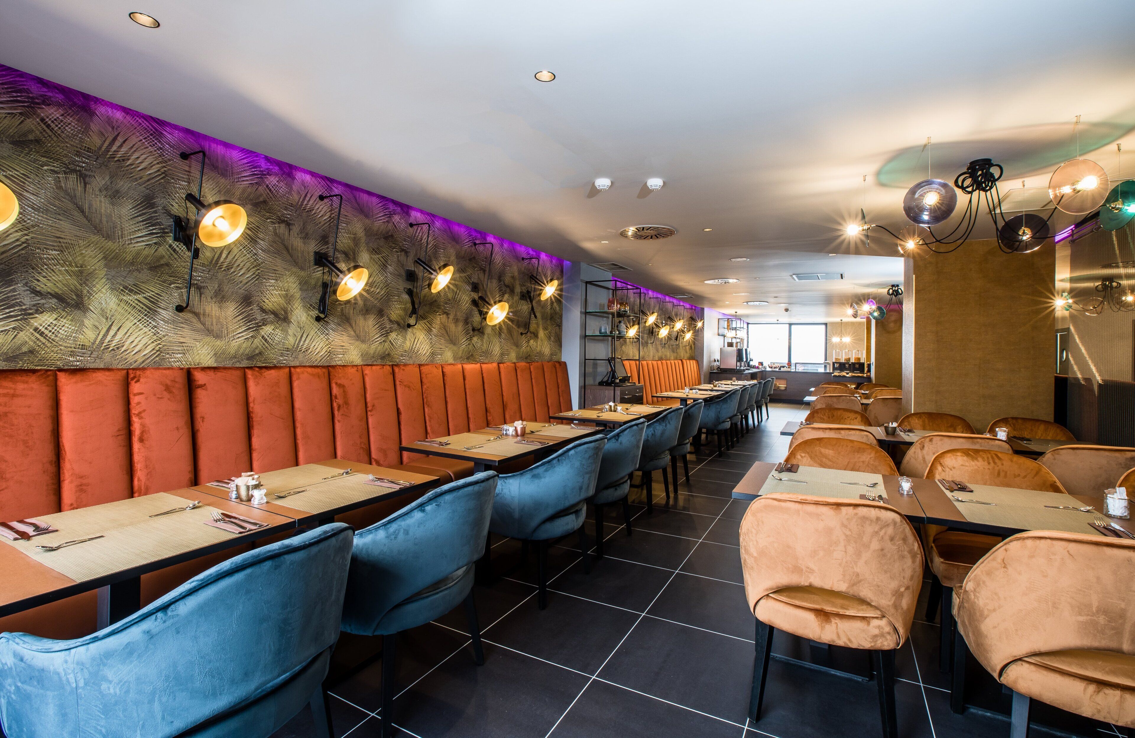 A restaurant interior with booths, tables, and a long counter.