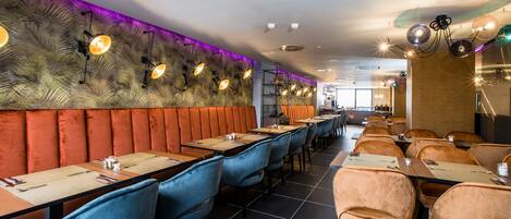A restaurant interior with booths, tables, and a long counter.