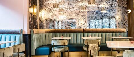 A restaurant interior with booths, tables, and a textured wall.