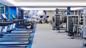 A gym with treadmills, elliptical machines, and weight machines.