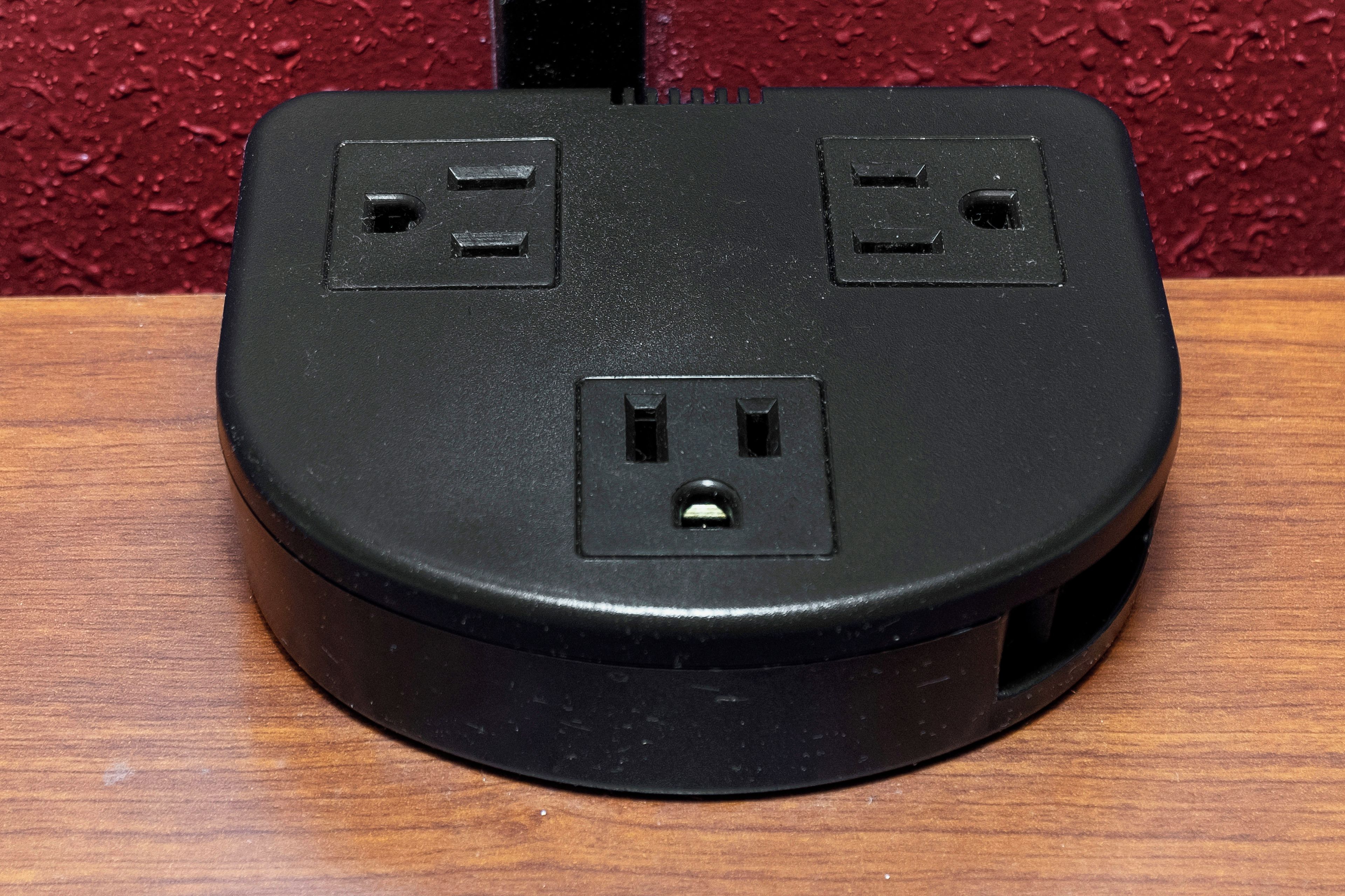 A black power strip with two standard electrical outlets and a USB port.