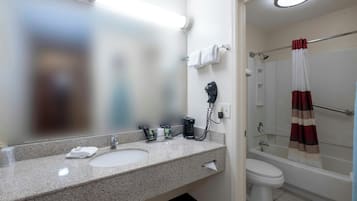 A bathroom with a sink, toilet, and shower.