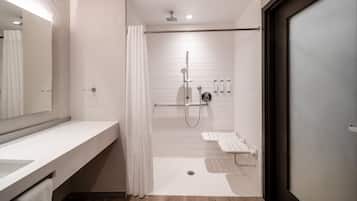 A modern bathroom with a shower, a sink, and a toilet.