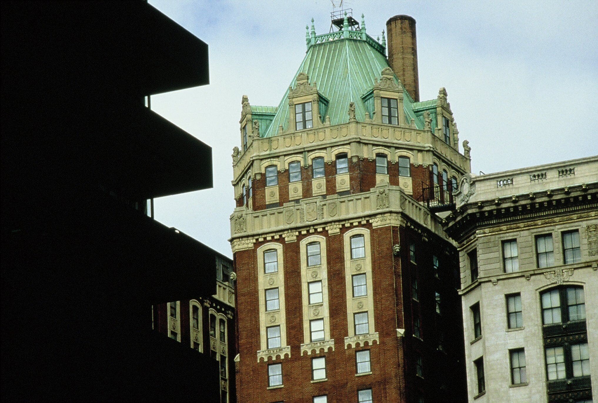 A historic building with a green roof and brick facade.