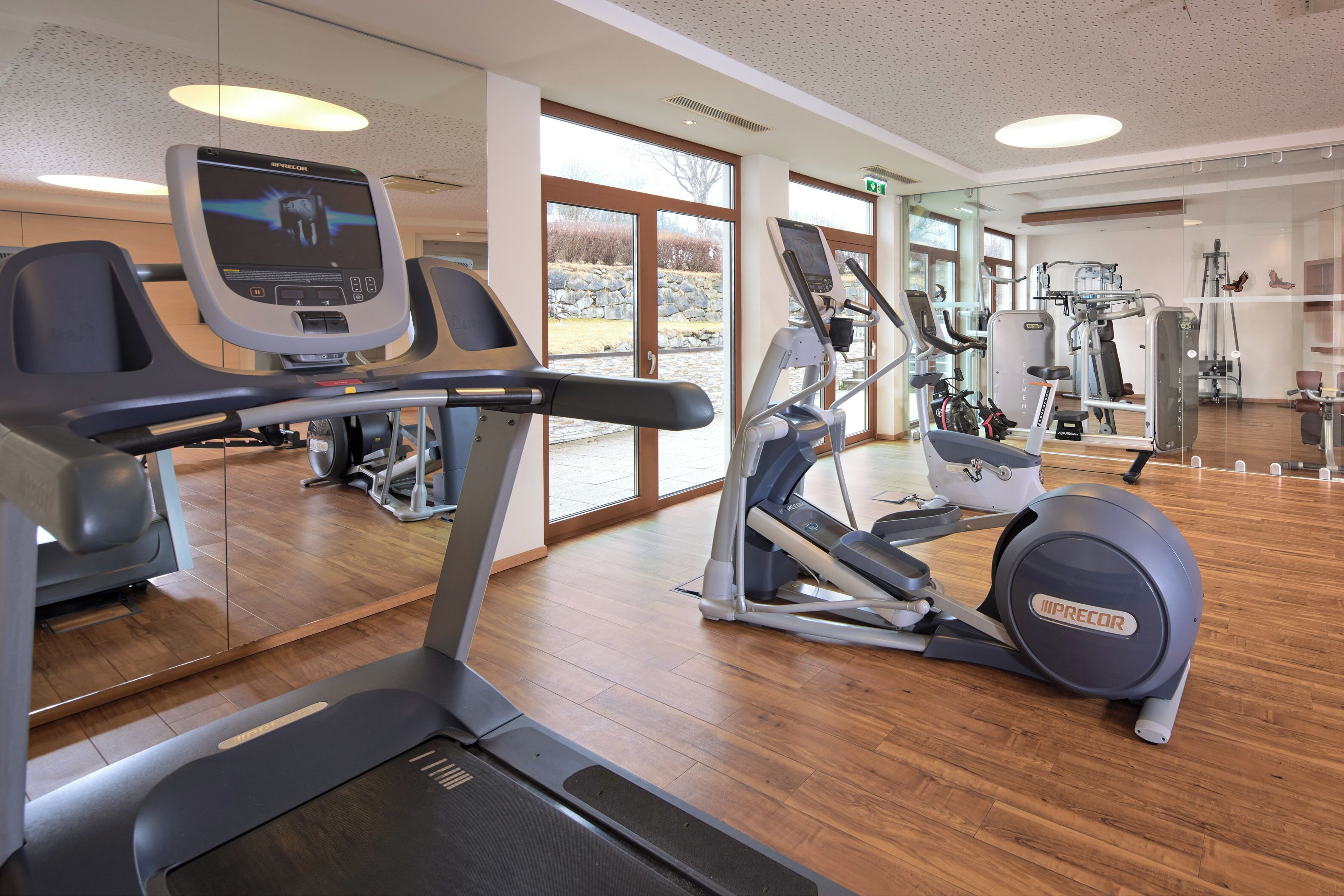 A gym with treadmills, elliptical machines, and weight equipment.